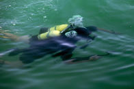 Two Russian navy divers practice at the Russian naval facility in Tartus, Syria, Thursday, Sept. 26, 2019. Russia has a naval base in Tartus, the only such facility it has outside the former Soviet Union. (AP Photo/Alexander Zemlianichenko)