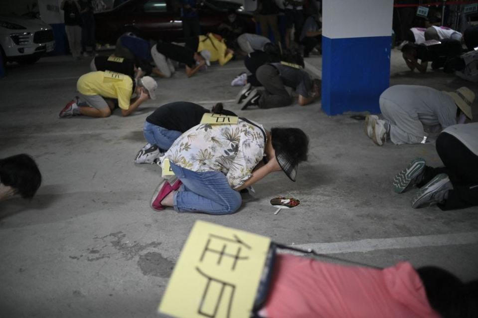 Local residents take shelter during the Wanan Air Raid Drill, a civilian air-raid drill held on the same day of the annual Han Kuang military exercises, in Taipei on July 25, 2022.