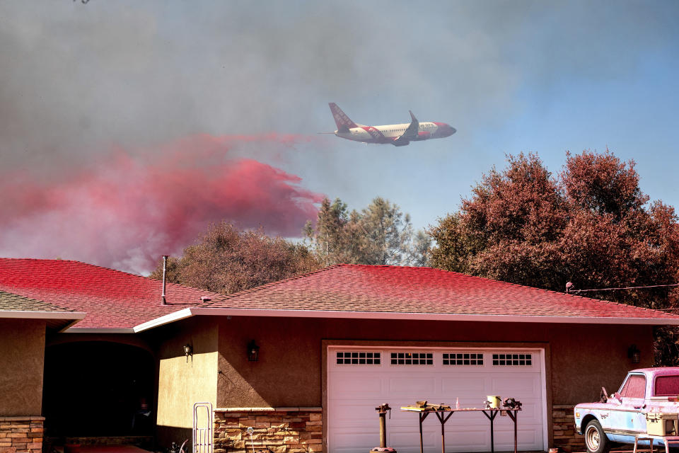An air tanker drops fire retardant while trying to keep the Grubbs Fire from spreading in the Palermo community of Butte County, Calif., on Wednesday, July 3, 2024. Firefighters stopped the fire at around 10 acres. (AP Photo/Noah Berger)
