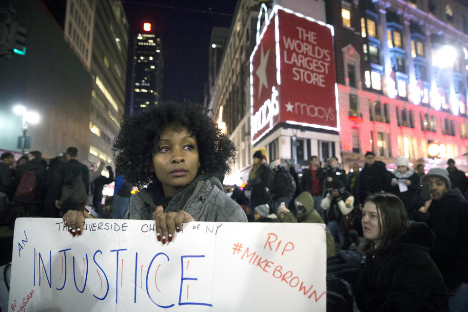 Protestor Rayyan Ali cries as she protests in Herald Square Thursday, Dec. 4, 2014, in New York, in response to a grand jury's decision not to indict the police officer involved in the death of Eric Garner. A grand jury cleared a white New York City police officer Wednesday in the videotaped chokehold death of Garner, an unarmed black man, who had been stopped on suspicion of selling loose, untaxed cigarettes. (AP Photo/John Minchillo)