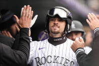 Colorado Rockies center fielder Brenton Doyle wears the ceremonial ski helmet and goggles as he returns to the dugout after hitting a home run off San Francisco Giants starting pitcher Keaton Winn in the fourth inning of a baseball game Thursday, May 9, 2024, in Denver. (AP Photo/David Zalubowski)