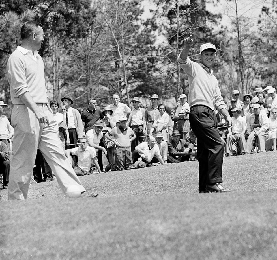 Arnold Palmer flashes a broad grin April 7,1960 and points down the fairway after shooting from the third tee in Masters Golf opening round at Augusta, Ga. Palmer, from Ligonier, Pa. took an early lead with a five-under-par 67. (AP Photo/hc)