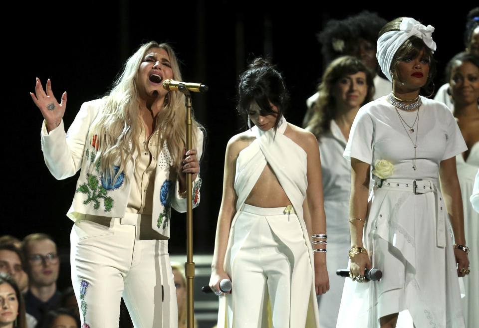 FILE - In this Jan. 28, 2018 file photo, Kesha, left, performs "Praying" as Camila Cabello, center, and Andra Day stand by at the 60th annual Grammy Awards at Madison Square Garden in New York. (Photo by Matt Sayles/Invision/AP, File)