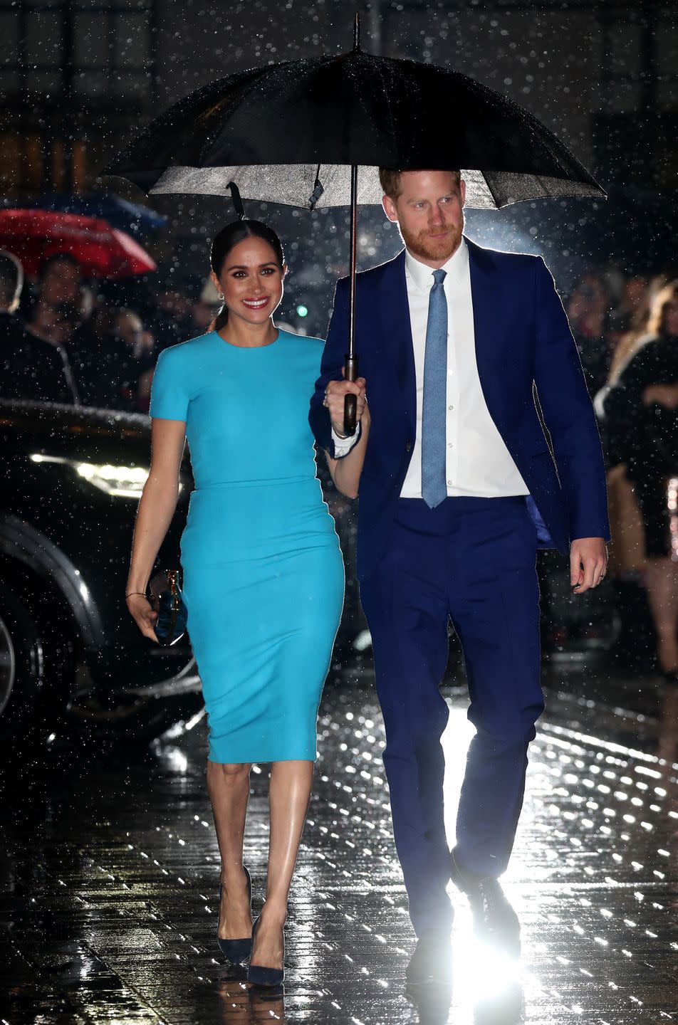 The rain did not phase the royal couple at all.