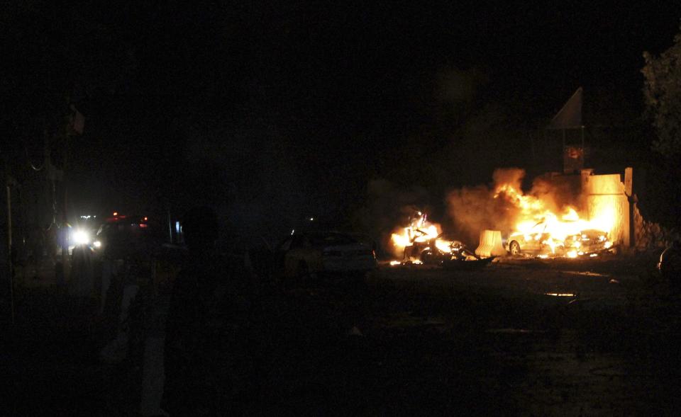 Fire burns at the scene of an explosion outside the Jazira hotel in Mogadishu