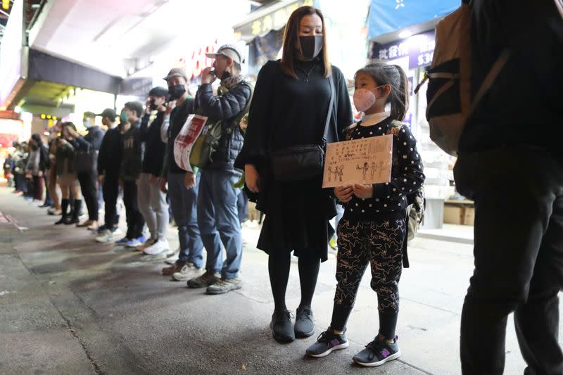 Anti-government demonstrators form a human chain protest on New Year’s Eve in Hong Kong