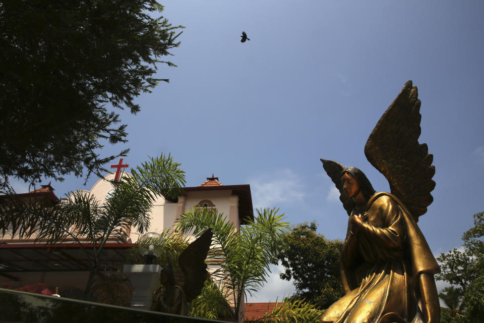 In this Thursday, April 25, 2019 photo, a bird flies over St. Sebastian's Church, where a suicide bomber blew himself up on Easter Sunday in Negombo, north of Colombo, Sri Lanka. Nearly a week later, the smell of death is everywhere, though the bodies are long gone. From inside, you see destruction wherever you look. But from outside the church, if you ignore the police tape and if you’re standing far enough away, you might think nothing had happened there at all. (AP Photo/Manish Swarup)