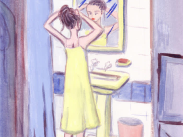 woman looking in mirror