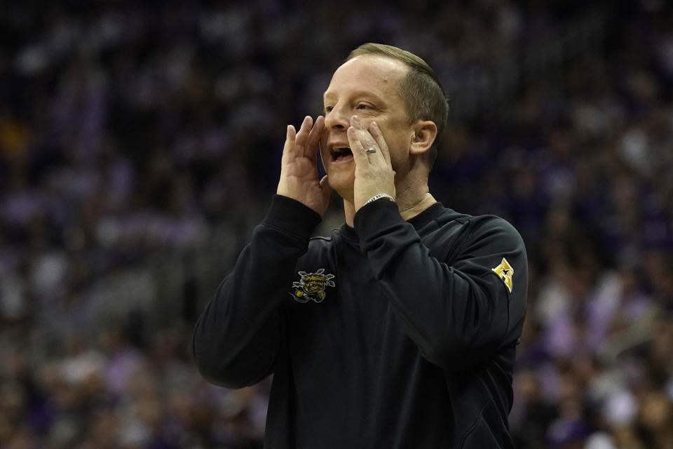 Wichita State head coach Paul Mills talks to his players during the first half of an NCAA college basketball game against Kansas State Thursday, Dec. 21, 2023, in Kansas City, Mo. (AP Photo/Charlie Riedel)