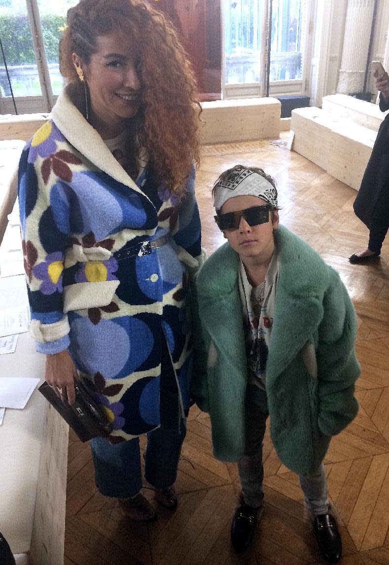 Fashion designer Natasha Zinko poses with her son Ivan, 9, one of the world's youngest fashion designers, before Valentino's fall-winter 2017/2018 ready to wear fashion collection is presented as part of Paris Fashion Week in Paris, Sunday, March 5, 2017. (AP Photo/Thomas Adamson)
