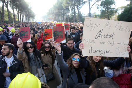 Students of public universities shows the Constitution and protest against higher tuition fees in Tirana, Albania, December 11, 2018. REUTERS/Florion Goga