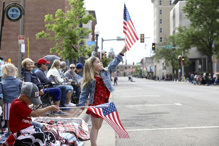 Ty Setter, left, 7, and his sister Ella Setter, 4, both of Rockford, play with their flags while waiting for the start of the Memorial Day Parade Monday, May 31, 2021, in downtown Rockford. The 2023 Memorial Day Parade is scheduled for 9 a.m. Monday.