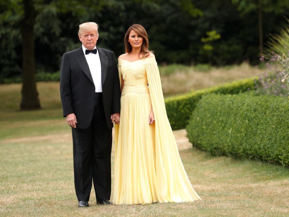 Donald and Melania Trump in the UK. Melania wears a yellow dress.
