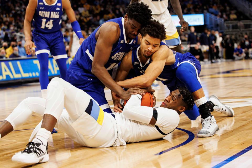 Marquette Golden Eagles forward Olivier-Maxence Prosper (12) battles Seton Hall Pirates forward Alexis Yetna (10) and guard Bryce Aiken (1) for control of the ball during the first half at Fiserv Forum.
