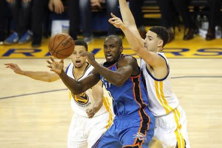 May 26, 2016; Oakland, CA, USA; Oklahoma City Thunder forward Serge Ibaka (9) loses control of the ball betweeen Golden State Warriors guard Stephen Curry (30) and guard Klay Thompson (11) in the second quarter in game five of the Western conference finals of the NBA Playoffs at Oracle Arena. Mandatory Credit: Cary Edmondson-USA TODAY Sports