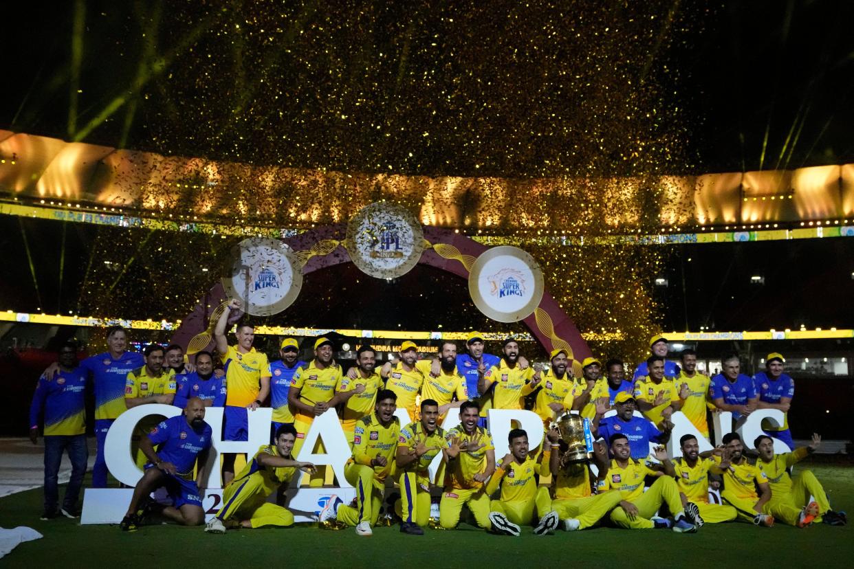 Chennai Super Kings players celebrate with the winners trophy after their win in the Indian Premier League final cricket match against Gujarat Titans in Ahmedabad, India, Tuesday, May 30, 2023. (AP Photo/Ajit Solanki)