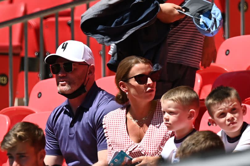 Former English football player Wayne Rooney (L), his wife Coleen and two boys wait for the UEFA EURO 2020 Group D football match between England and Croatia at Wembley Stadium in London on June 13, 2021.