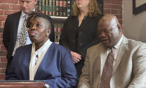 The parents of a teen who died after eating a spicy chip, Lois and Amos Wolobah, participate in a press conference announcing the filing of a lawsuit in the case, Thursday, July 11, 2024, in Boston. Harris Wolobah, a 10th grader from the city of Worcester, died Sept. 1, 2023, after eating the Paqui chip as part of the manufacturer’s “One Chip Challenge.” (AP Photos/Michael Casey)