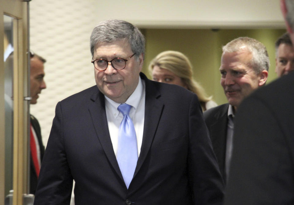 FILE - In this May 29, 2019 file photo, U.S. Attorney General William Barr, left, and U.S. Sen. Dan Sullivan, R-Alaska, right, arrive at a roundtable discussion at the Alaska Native Tribal Health Consortium in Anchorage, Alaska. Alaska Native villages are receiving almost $5 million from the U.S. Justice Department to combat numerous public safety problems, including no law enforcement presence in some communities. The announcement Tuesday, July 30, 2019, comes nearly two months after Barr met with tribal representatives during a visit to the state who detailed slow response times from authorities, violence against women and abuse of alcohol and drugs, including opioids. (AP Photo/Mark Thiessen, File)