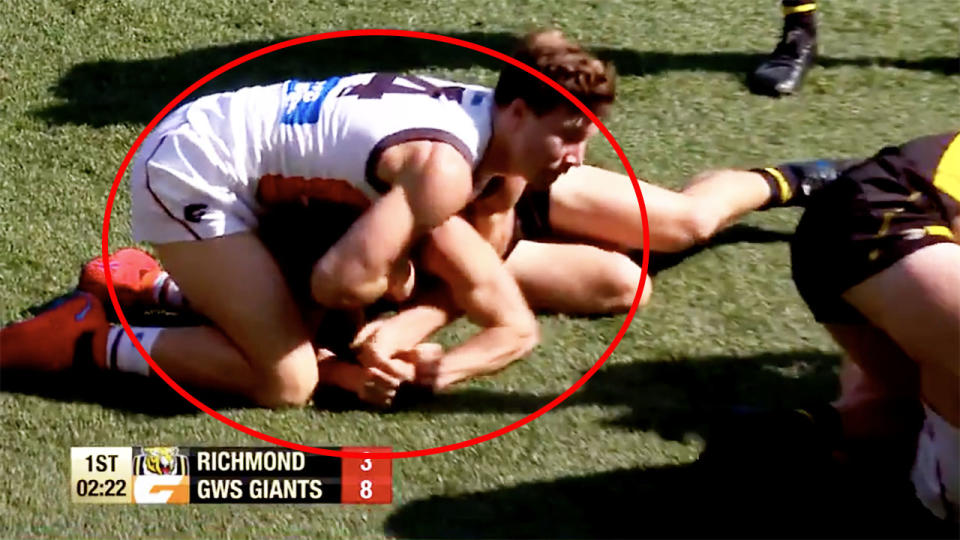 GWS Giants star Toby Greene, pictured appearing to put his hands on a Richmond opponent's face.