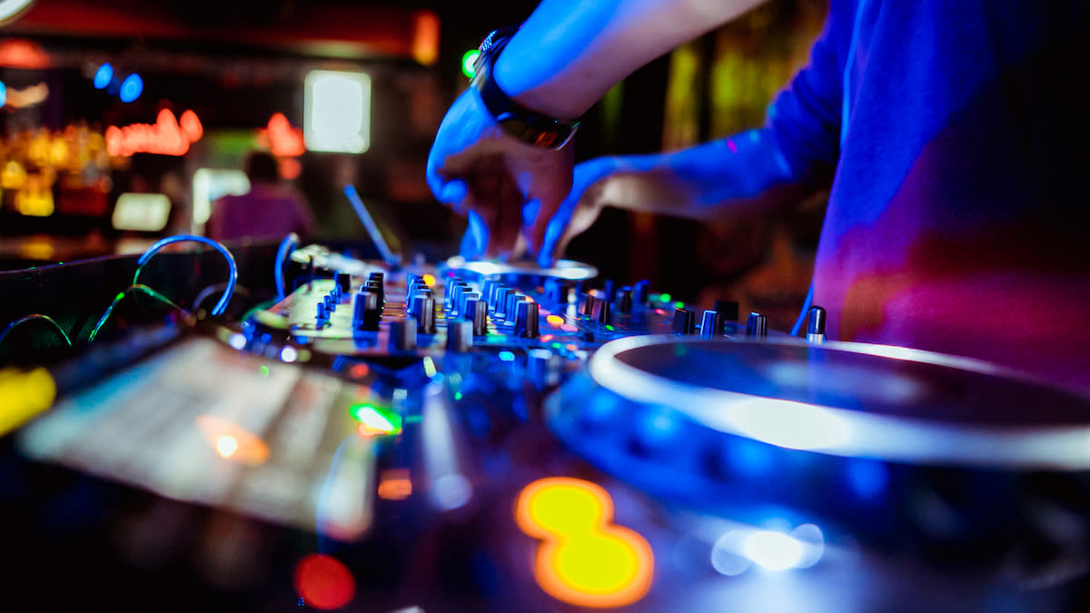  Person DJing in a nightclub. 