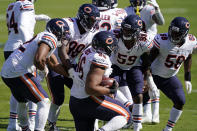 Chicago Bears defensive end Akiem Hicks (96) is congratulated by teammates following a turnover during the second half of an NFL football game against the Carolina Panthers in Charlotte, N.C., Sunday, Oct. 18, 2020. (AP Photo/Brian Blanco)