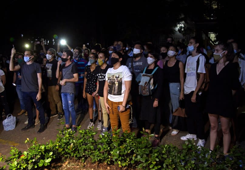 Young artists protest in front of the doors of the Ministry of Culture, in Havana, Cuba, Friday, Nov. 27, 2020. Dozens of Cuban artists demonstrated against the police evicting a group who participated in a hunger strike. (AP Photo/Ismael Francisco)