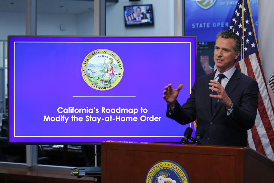 FILE - In this April 14, 2020, file photo, California Gov. Gavin Newsom gestures during a news conference at the Governor's Office of Emergency Services in Rancho Cordova, Calif. On Wednesday, April 22, Gov. Newsom is scheduled to give an update on the six indicators state officials are watching to determine when they might loosen the state's stay-at-home order to prevent the spread of the coronavirus. (AP Photo/Rich Pedroncelli, Pool, File)