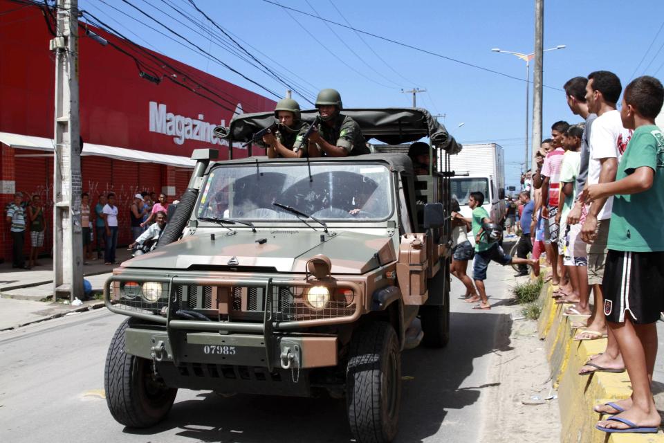 Army soldiers patrol a street during a police strike in Recife