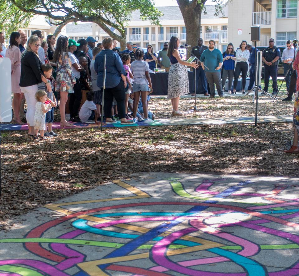 At center, Ruthie Noel, with the Leadership Pensacola Class of 2022, speaks Tuesday during the grand opening celebration for the Born Learning Trails at Highland Terrace Park in Pensacola.