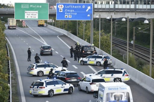 Police block a road to the Oresund bridge near Copenhagen, on September 28, 2018 during a manhunt for three Iranian suspects