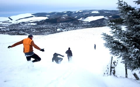 Cross country runners set off through heavy snow around Peebles in the Scottish Borders - Credit: David Cheskin/PA Wire