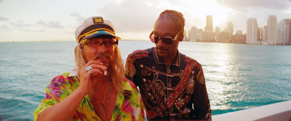 Matthew McConaughey and Snoop Dogg stand on a boat