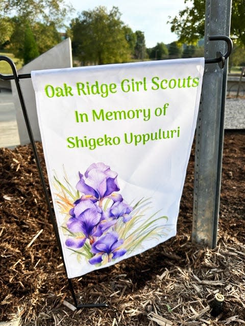 The Girl Scouts planted a banner telling passersby the reason for their planting of irises at the International Friendship Bell garden at A.K. Bissell Park in Oak Ridge.