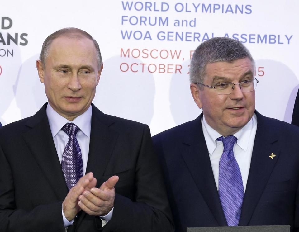 Will IOC president Thomas Bach (R) ban Vladimir Putin’s Russia from the Rio Games? (AP)