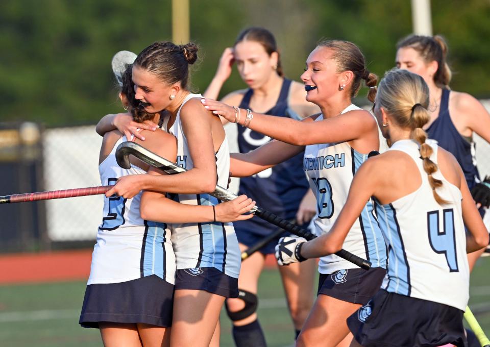 Quinn Jordan, Alivia Barnes (18) and Sadie Clarkin join Elisabeth Stutzman (left) after she scored Sandwich's only and winning goal against Cohasset.