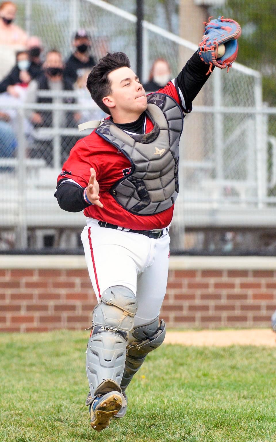 Edgewood catcher Brayden Ault catches a pop-up for an out during a game against Bloomington South in Ellettsville during the 2021 season.