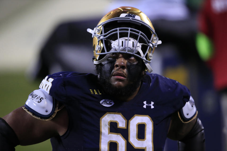 FILE - Notre Dame offensive lineman Aaron Banks (69) looks into the stands as he walks off the field following their loss to Clemson at the Atlantic Coast Conference championship NCAA college football game in Charlotte, N.C., in this Saturday, Dec. 19, 2020, file photo. Banks was selected to The Associated Press All-America first-team, Monday, Dec. 28, 2020. (AP Photo/Brian Blanco, File)