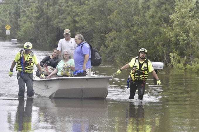 CORRECTS DATE TO SEPT. 17 NOT AUG. 17 Members of a citizen response team from Indiana assist in high water rescue of residents, Thursday, Sept. 17, 2020 in Pensacola, Fla. Homeowners and businesses along the soggy Gulf Coast have begun cleaning up in the wake of Hurricane Sally, even as the region braces for a delayed, second round of flooding in the coming days from rivers and creeks swollen by the storm's heavy rains. (Tony Giberson/Pensacola News Journal via AP)