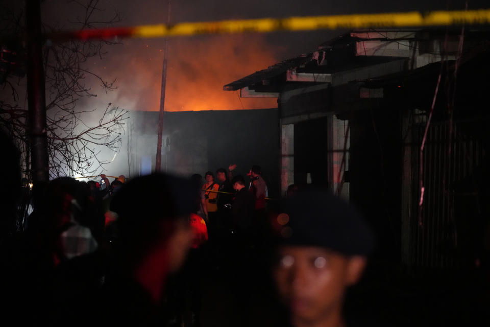 CORRECTS DATE Rescuers inspect a neighborhood affected by a large fire in Jakarta, Indonesia, Friday, March 3, 2023. The fire broke out at a fuel storage depot in Indonesia's capital on Friday, killing a number of people, injuring dozens of others and forcing the evacuation of thousands of nearby residents after spreading to their neighborhood, officials said. (AP Photo/Dita Alangkara)