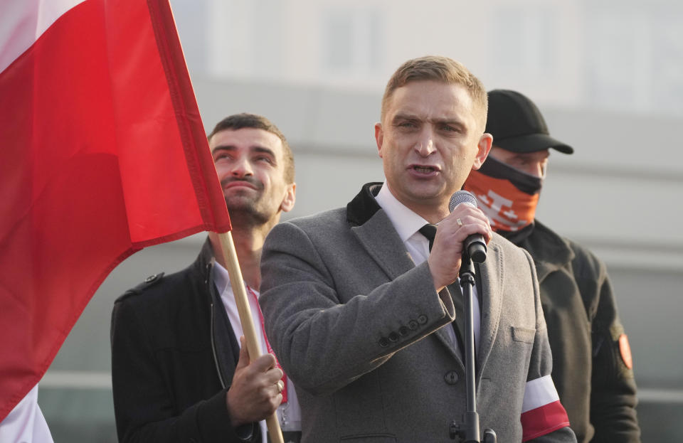 Leader of the far-right, Robert Bakiewicz speaks at the start of the annual Independence Day march in Warsaw, Poland, on Thursday, Nov. 11, 2021. The marching far-right groups were calling for strong borders, as Poland's troops blocked hundreds of attempts by migrants to enter the country illegally from neighboring Belarus in a tense political standoff. (AP Photo/Czarek Sokolowski)