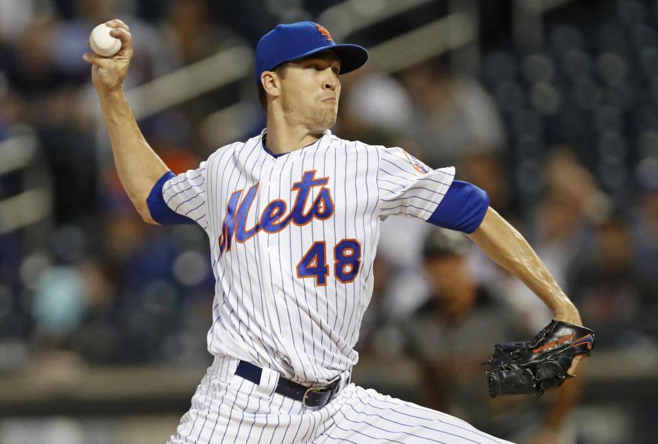 FILE - In this Sept. 9, 2019, file photo, New York Mets starting pitcher Jacob deGrom winds up during the first inning of the team's baseball game against the Arizona Diamondbacks in New York. Mets' deGrom has been named the NL Cy Young Award winner for the second straight year. (AP Photo/Kathy Willens, File)