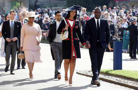 Idris Elba and Sabrina Dhowre followed by Oprah Winfrey (fourth right) arrive at St George's Chapel at Windsor Castle for the wedding of Meghan Markle and Prince Harry. Saturday May 19, 2018. Chris Radburn/Pool via REUTERS