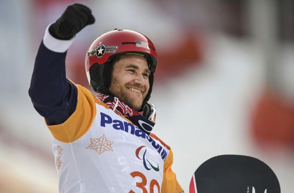 Mike Schultz celebrates his gold-medal snowboard run at the Winter Paralympics on March 12.