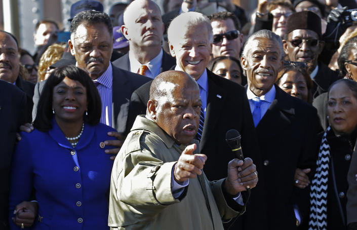 Rep. John Lewis, D-Ga., points to where he and others were beaten 48 years ago when they tried to cross the Edmund Pettus Bridge during a civil rights march in Selma, Ala., Sunday, March 3, 2013. At rear is Vice President Joe Biden. At left is U/S. Rep. Terri Sewell, D-Ala., Jesse Jackson is second from left. (Photo: Dave Martin/AP)