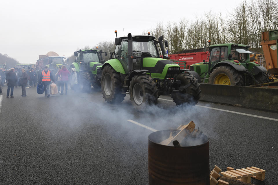 Farmers block a highway during a demonstration Tuesday, Jan. 23, 2024 near Beauvais, northern France. Farmers have for months been protesting for better pay and against what they consider to be excessive regulation, mounting costs and other problems. (AP Photo/Matthieu Mirville)