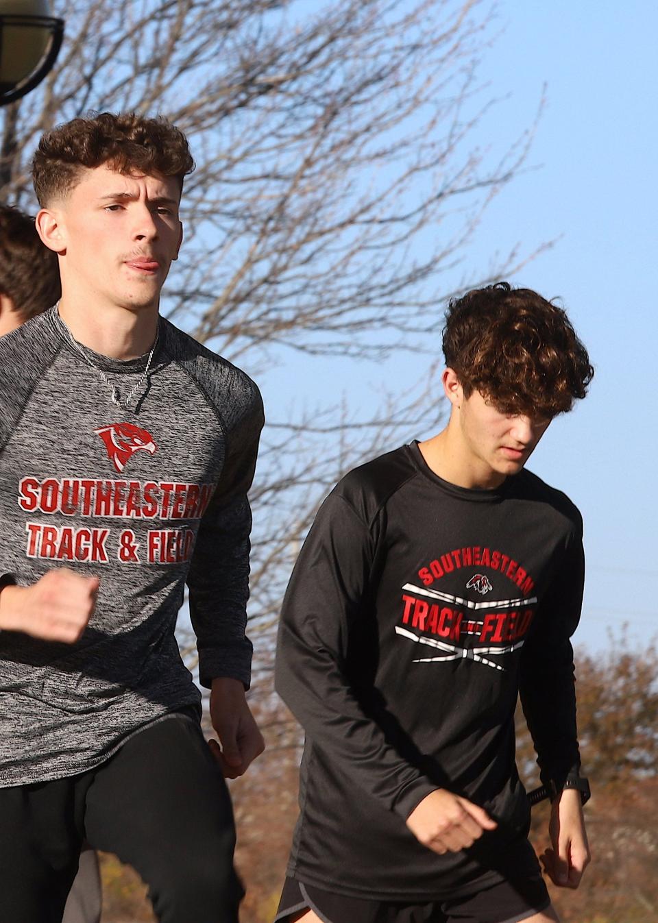 SCC men's cross country runners Devin Taylor, left, and Brooks Julian warm up during practice Wednesday on the campus in West Burlington.