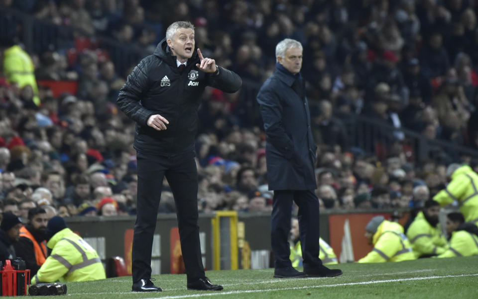 Manchester United's manager Ole Gunnar Solskjaer, left, gives instructions from the side line as Tottenham's manager Jose Mourinho looks on during the English Premier League soccer match between Manchester United and Tottenham Hotspur at Old Trafford in Manchester, England, Wednesday, Dec. 4, 2019. (AP Photo/Rui Vieira)