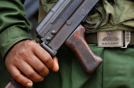 United Wa State Army (UWSA) soldier holds a weapon as he marches during a festival in a village outside Pansang, Wa territory in northeast Myanmar October 3, 2016. Picture taken on October 3, 2016. REUTERS/Soe Zeya Tun