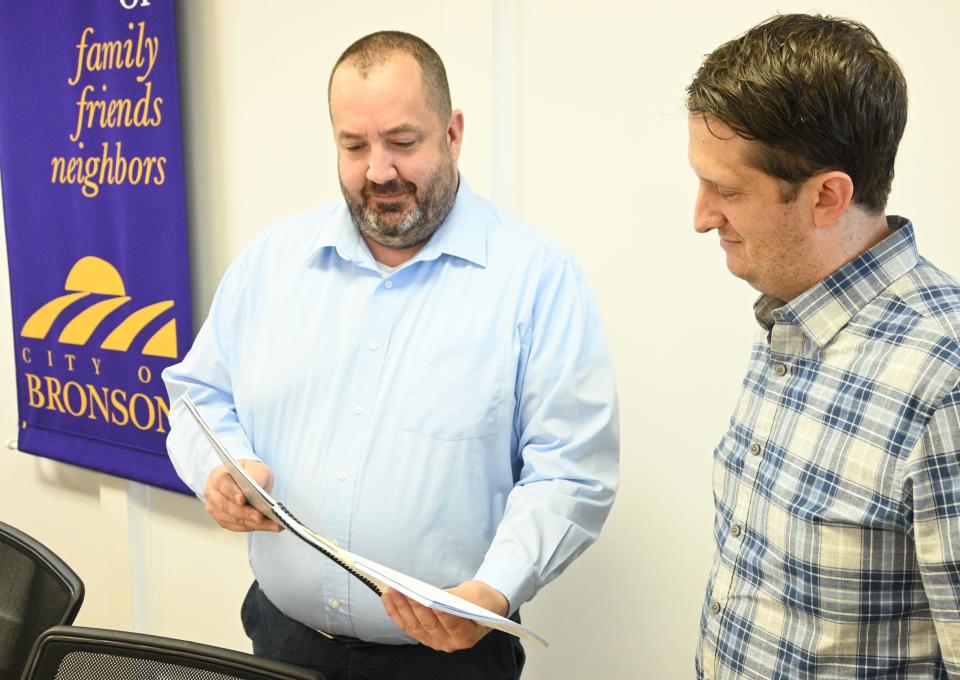 CEDAM fellow Patrick Bird and Bronson City Manager Brandon Mersman go over the proposed new city master plan which will be available for public inspection and comment Friday at the Food Truck Rally.